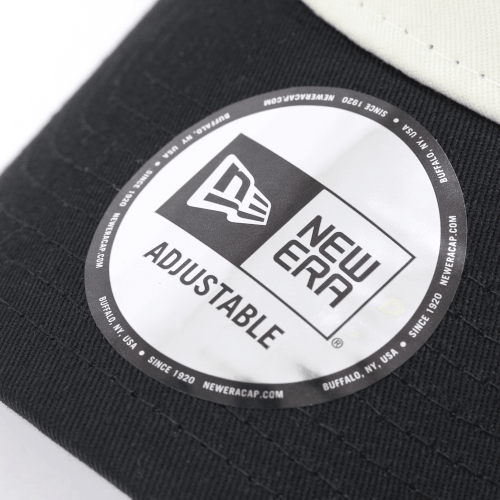 Close-up of the 2-tone Mesh Cap logo from New Era showing adjustable feature.