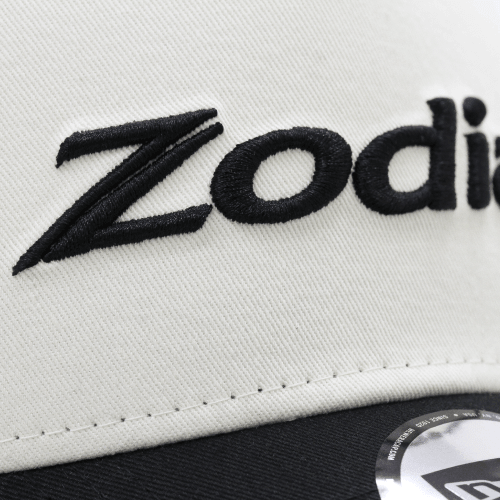 Close-up of the 2-tone Mesh Cap featuring Zodia logo on cream front panel and black brim.