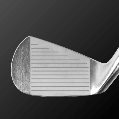 Close-up view of the head of the Caiman IV CB golf club, showcasing its polished face and precision grooves.