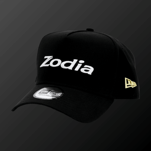 Metal Badge Cap featuring Zodia logo and NEW ERA flag in metal badge on a black cap.