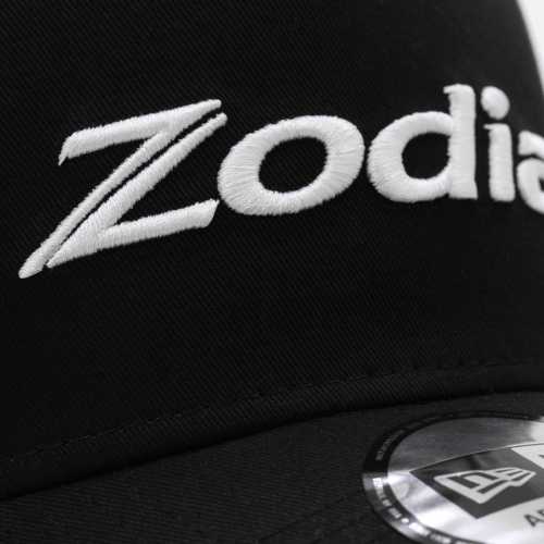 Close-up of the Zodia logo on the Metal Badge Cap, showcasing the embroidered detail on a black background.