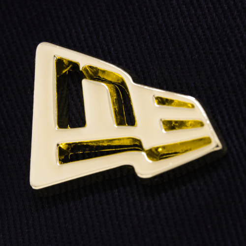 Metal Badge Cap featuring the NEW ERA flag logo in a gold metal badge design.