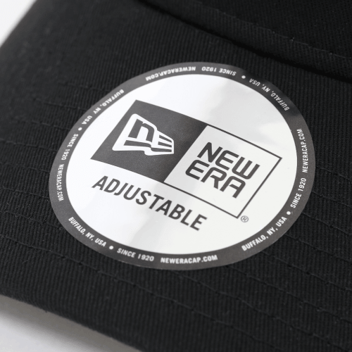 Close-up of the metal badge logo on a Metal Badge Cap by New Era, featuring an adjustable fit and classic design.