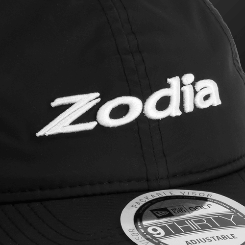 Close-up of Zodia logo on a Waterproof Rain Cap featuring packable and adjustable design.
