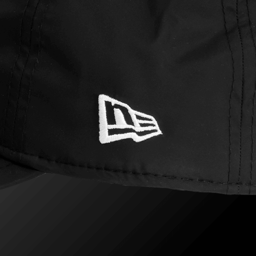 Waterproof Rain Cap logo detail in black and white on a stretchable waterproof fabric.