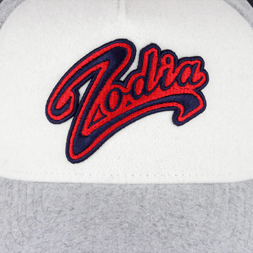 Zodia × NEW ERA Wool Cap featuring a stylish embroidery logo on a gray and white trucker cap.