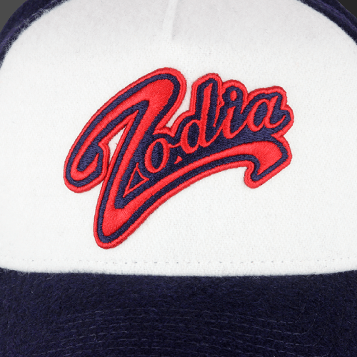 Zodia × NEW ERA Wool Cap featuring a prominent embroidered Zodia logo in red on a gray and navy background.